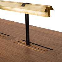Brass and black metal trim on a rich walnut wood surface with sleek, modern lines and cut-out patterns.