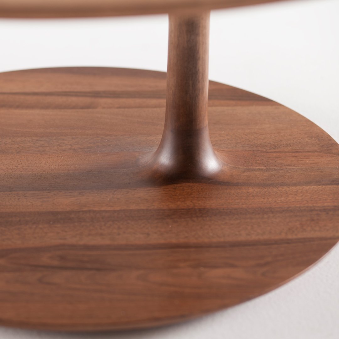 Dark walnut wood table base with smooth, natural grain patterns and a circular design. Ideal for modern spaces.