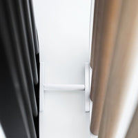 "Close-up of varied fabric colors: sleek black, warm beige, and soft taupe with vertical patterns and modern textures."