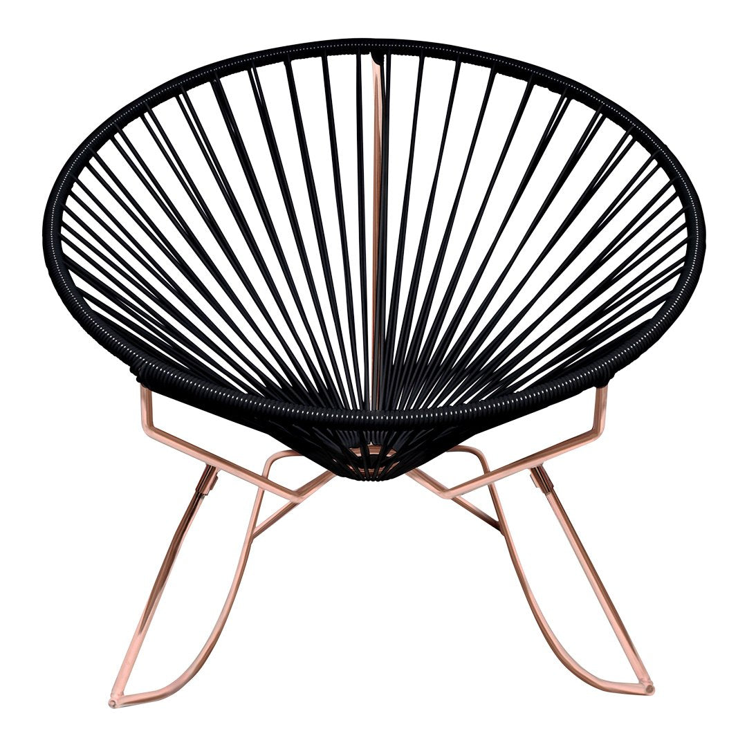 Black Acapulco chair with geometric pattern and rose gold metal legs, perfect for modern decor.