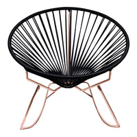 Black Acapulco chair with geometric pattern and rose gold metal legs, perfect for modern decor.