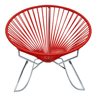 Red Acapulco chair with a circular design and radiating pattern, set on a sleek silver metal frame.