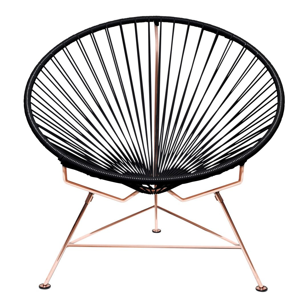 Black Acapulco chair with a sleek, modern design and rose gold metal frame. Perfect geometric lines and patterns.