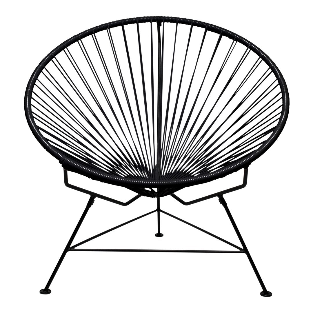 Black Acapulco chair featuring a sleek, radial pattern and minimalist metal frame. Ideal for modern decor.