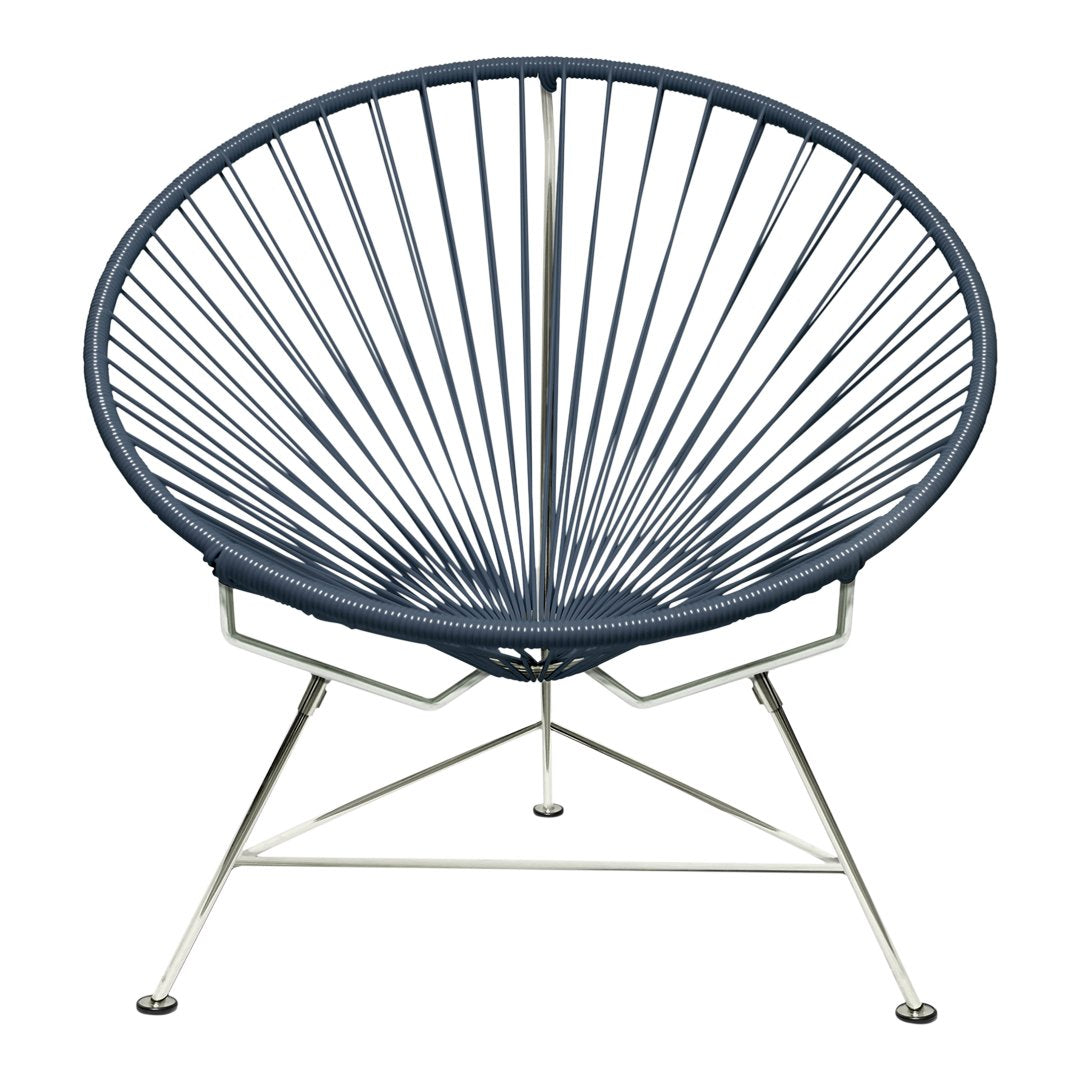 Navy blue Acapulco chair with distinctive radial pattern and sleek silver metal base. Perfect for modern decor.