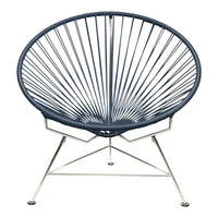 Navy blue Acapulco chair with distinctive radial pattern and sleek silver metal base. Perfect for modern decor.
