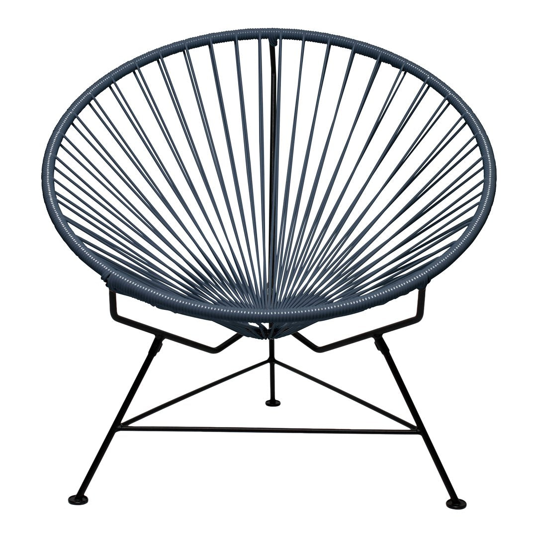 Acapulco chair in deep navy blue with a striking radial pattern and sleek black metal frame. Perfect for modern decor.