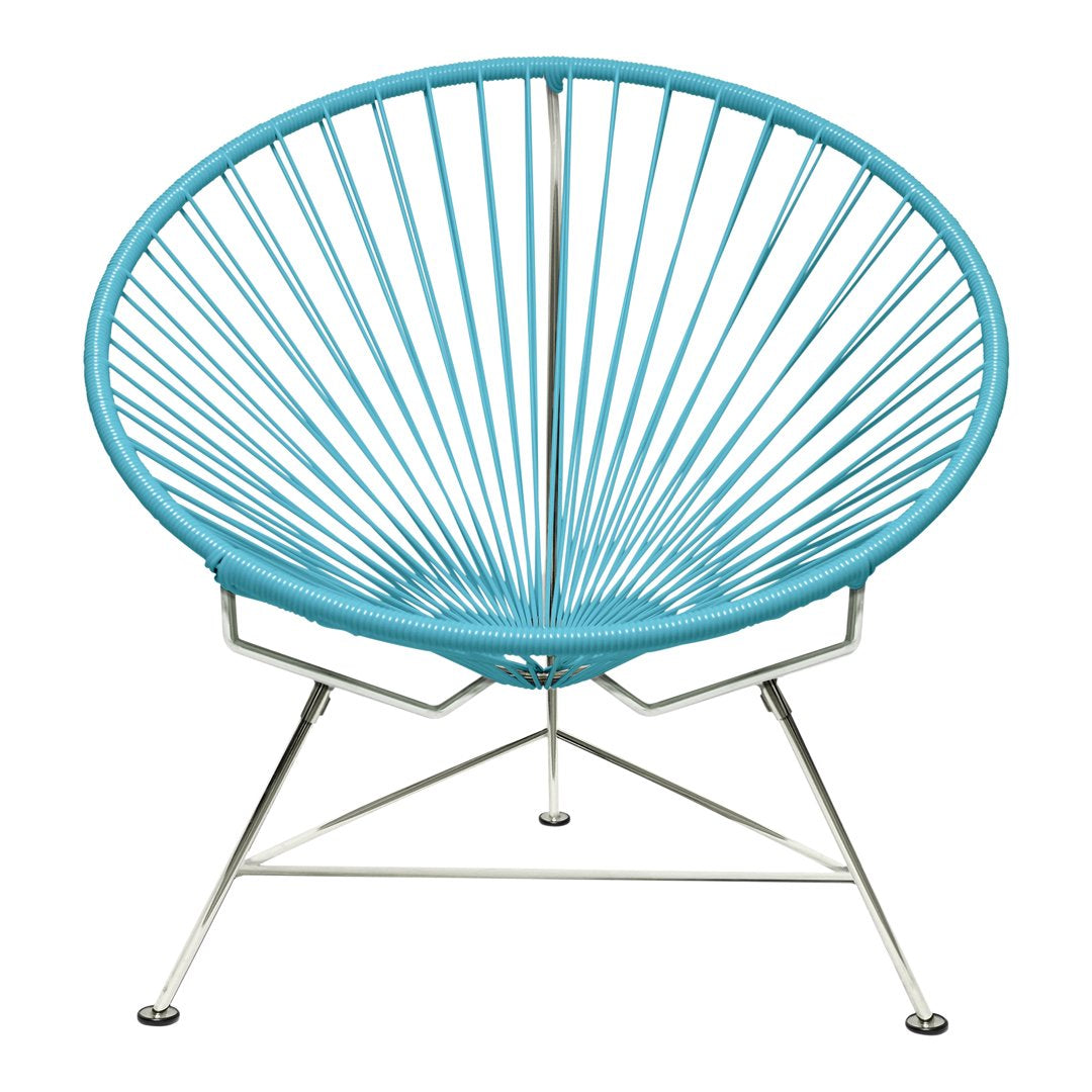 Vibrant turquoise Acapulco chair with a unique radiating wire design on a sleek chrome base.