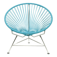 Vibrant turquoise Acapulco chair with a unique radiating wire design on a sleek chrome base.