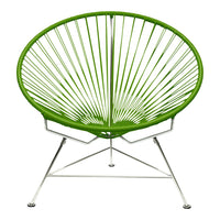 Vibrant green Acapulco chair with radial pattern and sleek silver legs, perfect for modern decor.