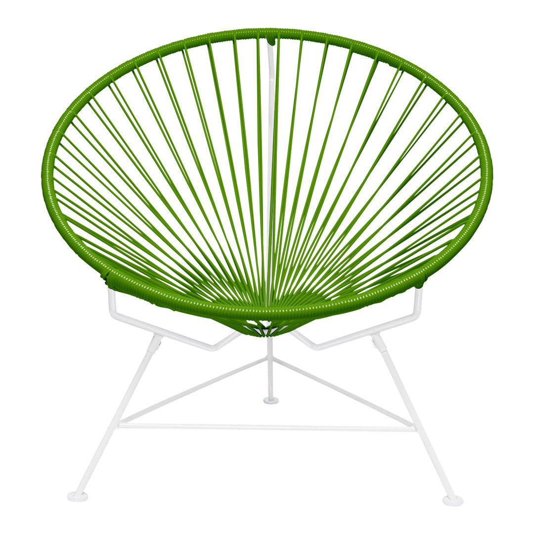 Vibrant green Acapulco chair with a unique radial pattern and smooth white metal frame. Perfect for modern decor.