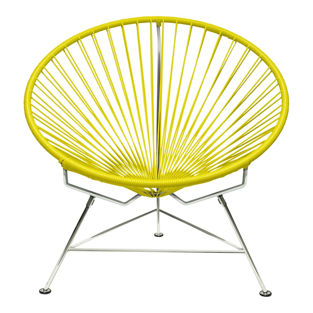 Yellow Acapulco chair featuring a bold radial pattern and sleek chrome legs for a modern look.