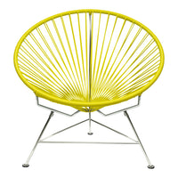 Yellow Acapulco chair featuring a bold radial pattern and sleek chrome legs for a modern look.