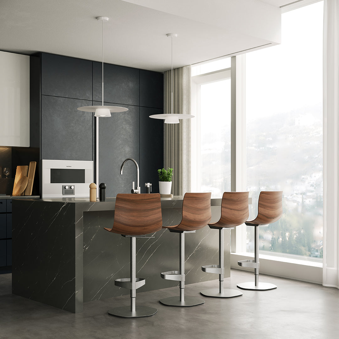 Modern kitchen featuring four wooden bar stools with a rich brown finish against a sleek black and gray backdrop.