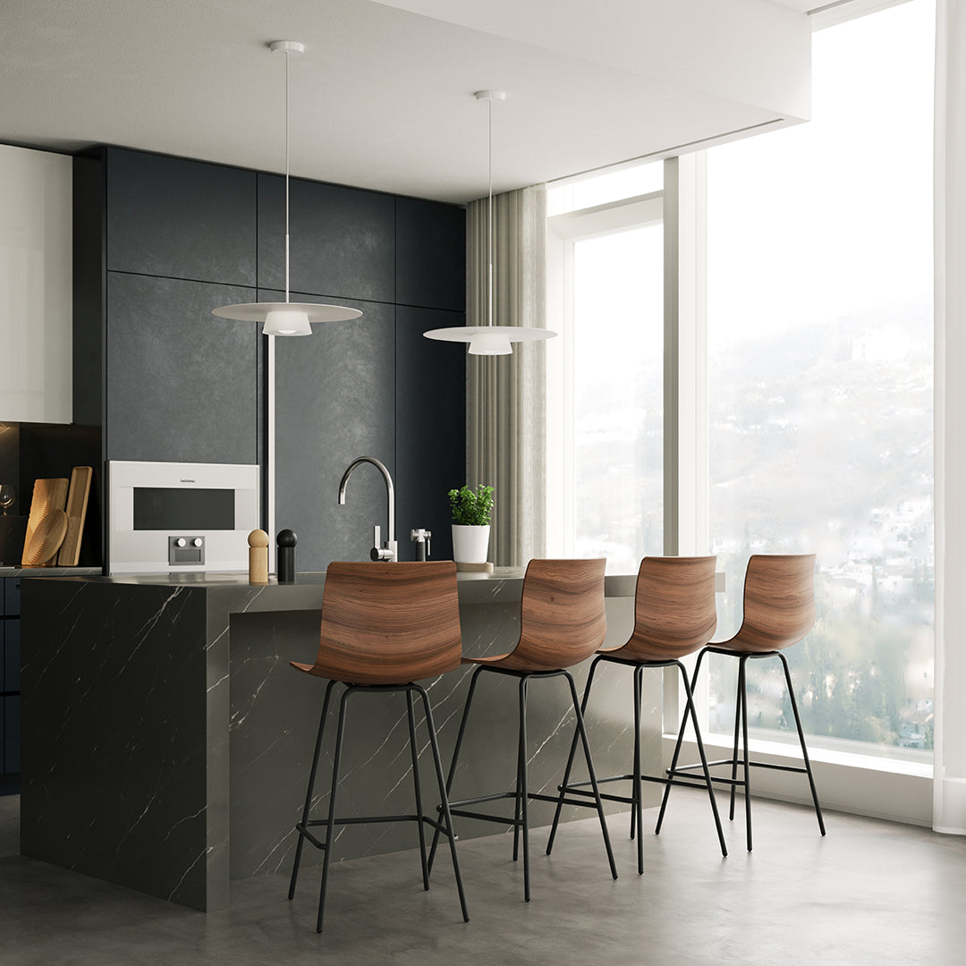 Brown wooden bar stools on black and gray stone kitchen island in modern, minimalist kitchen setting.