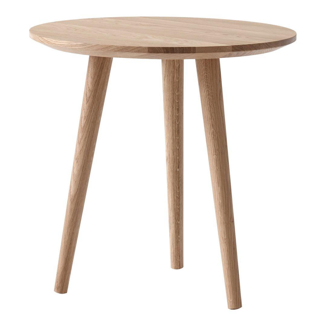 Natural oak round side table with smooth wood finish and tapered legs, showcasing a warm, minimalist design.