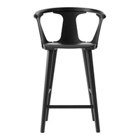 Black modern bar stool with a sleek minimalist design and open back pattern. Ideal for contemporary interiors.