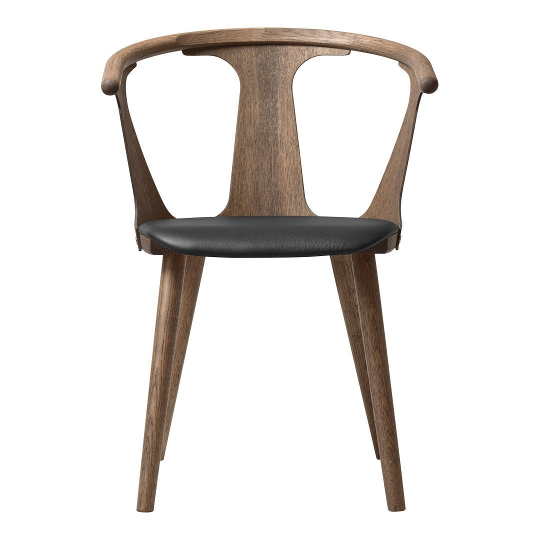 Wooden chair with a rich walnut finish and sleek black leather seat. Modern slatted back design enhances aesthetics.