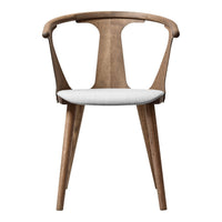 Light wood chair with a stylish curved design and a soft, white upholstered seat for a modern look.