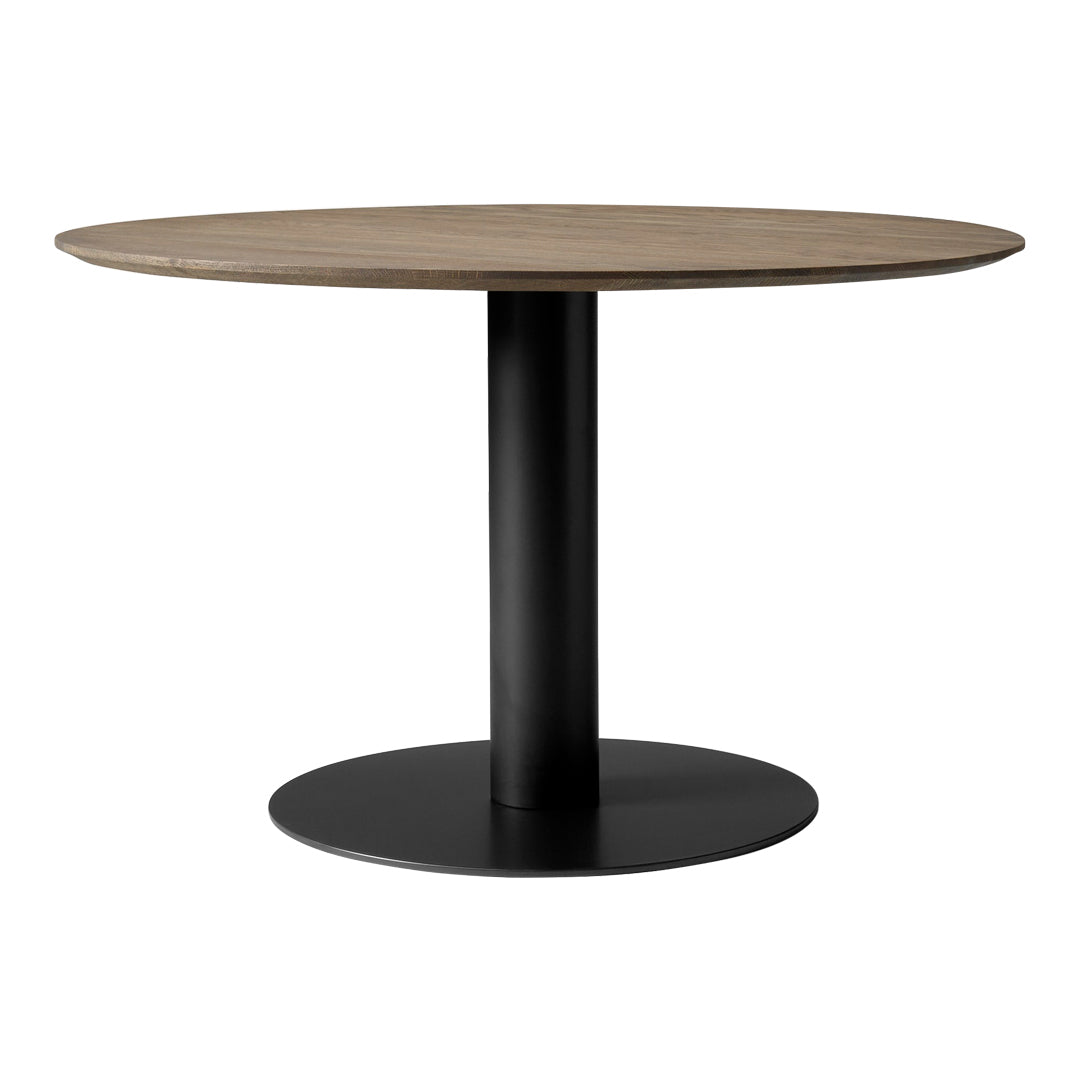 Round dining table featuring a natural wood top and a sleek black metal base. Modern and minimalist design.