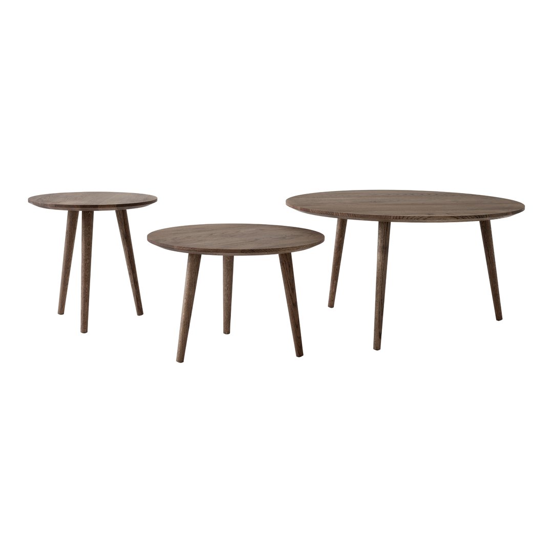 Set of three round wooden tables in a natural brown finish, featuring smooth surfaces and tapered legs.