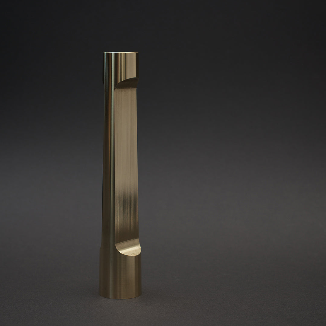 Sleek, vertical bronze vase with smooth, shiny finish on a dark background. Modern, minimalist design showcasing elegance.