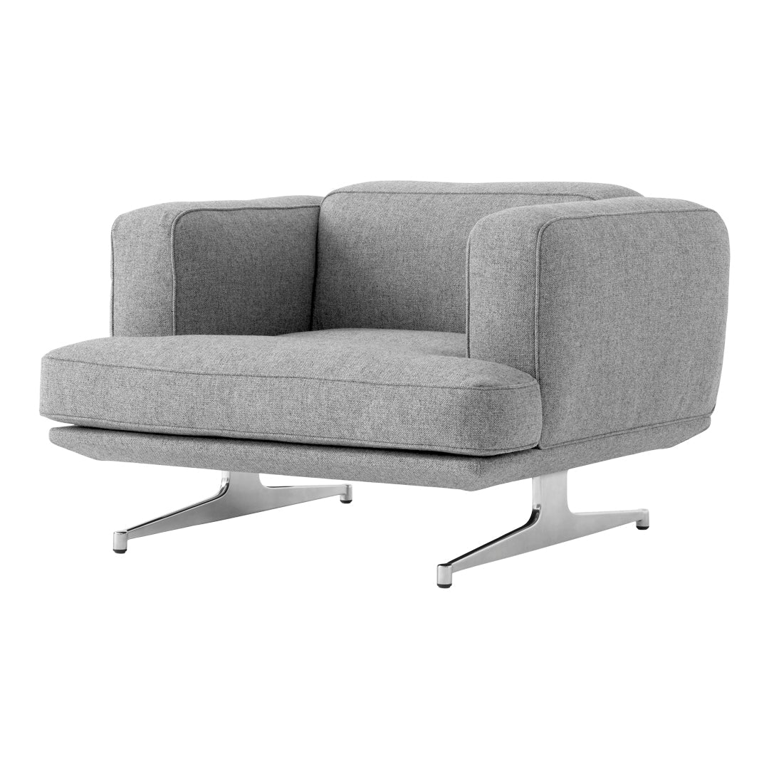 Modern gray armchair with a minimalist design and smooth fabric texture, featuring a sleek metal base.