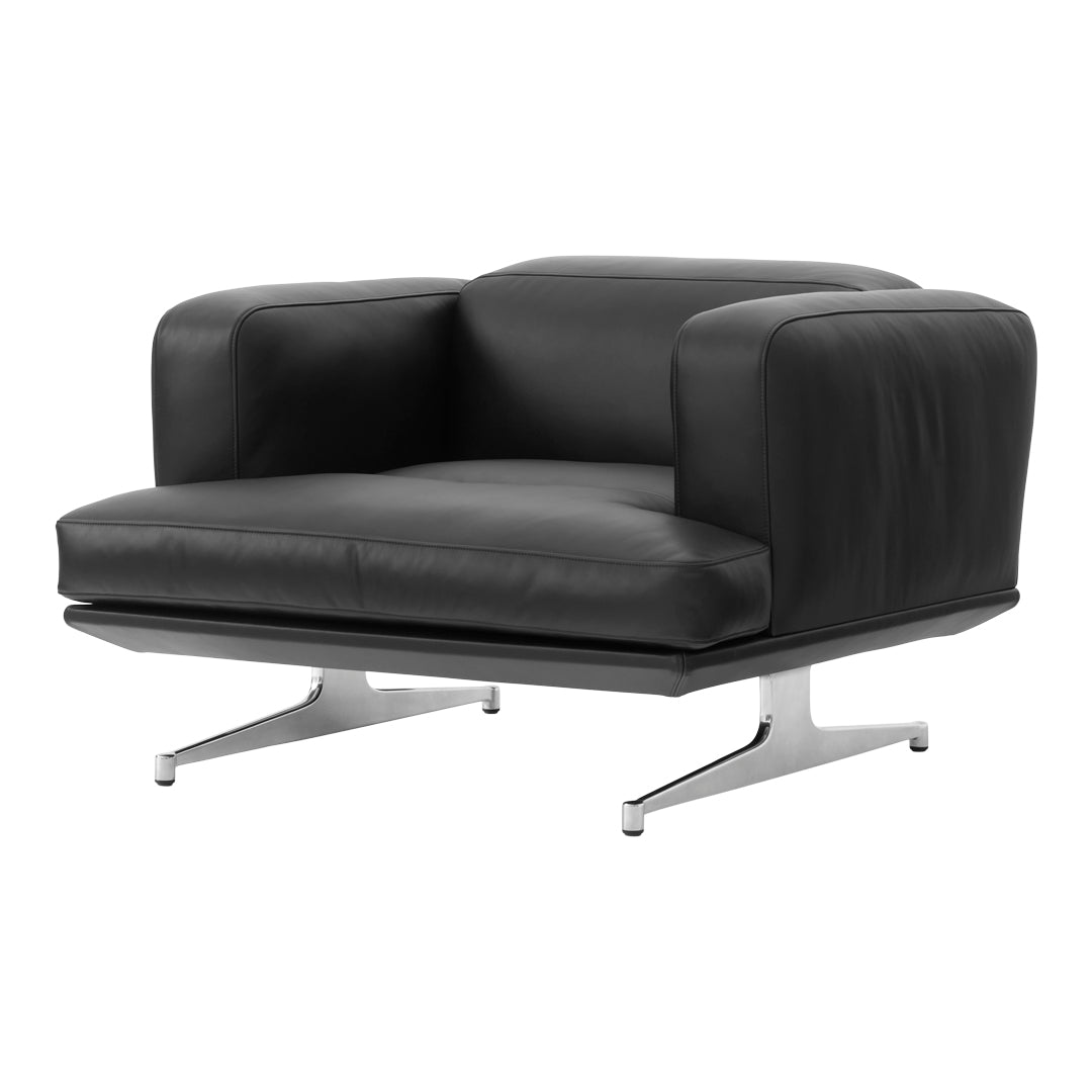 Black leather armchair with a sleek chrome base, showcasing a minimalist design and smooth texture.
