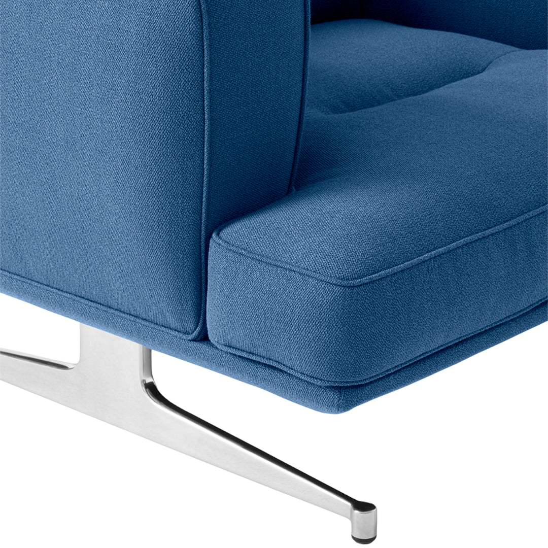 Blue upholstered chair with a sleek, tufted design and a polished chrome base. Modern and stylish accent piece.