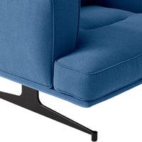 Textured blue fabric upholstery on a modern chair with sleek black metal legs.