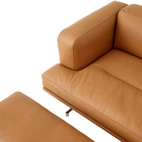 Tan leather sofa with smooth texture and minimalist design, featuring a matching ottoman. Perfect for modern interiors.
