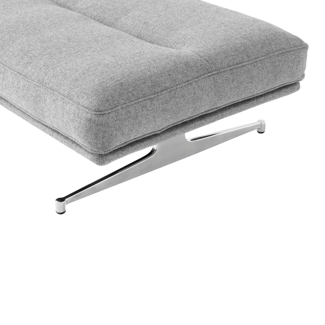 Gray padded cushion with a sleek chrome base, featuring a minimalist design and clean lines. Ideal for modern decor.