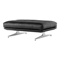 Black leather ottoman with a sleek, minimalist design, featuring a tufted pattern and modern chrome legs.