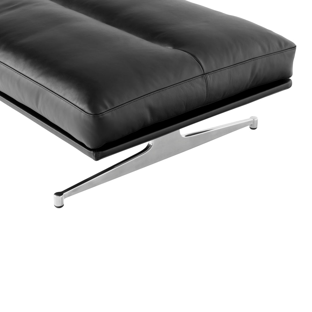 Black leather cushion with sleek chrome support, showcasing a minimalist design and smooth texture.