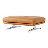 Tan leather ottoman with tufted detailing and sleek chrome legs, offering a modern, minimalist aesthetic.