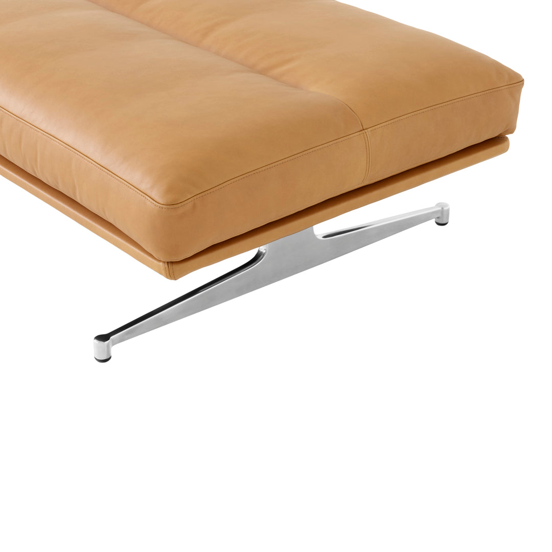 Tan leather sofa cushion with a sleek chrome base, offering a modern, minimalist design.