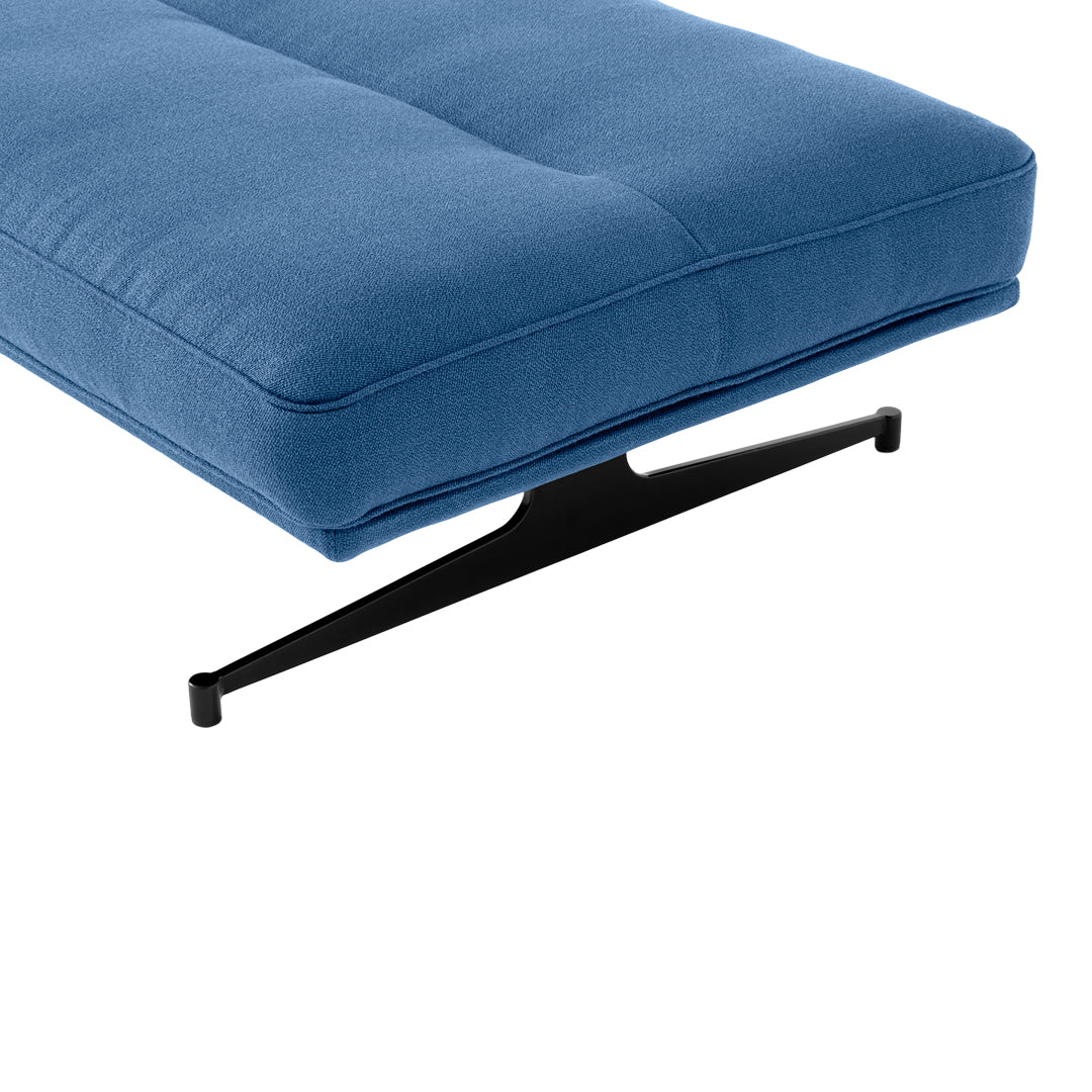 Blue upholstered cushion with a smooth, solid pattern and a sleek black metal base.