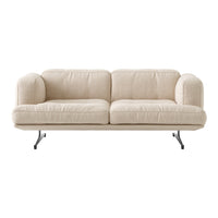 Beige sofa with a minimalist design, featuring soft, textured upholstery and sleek black metal legs.