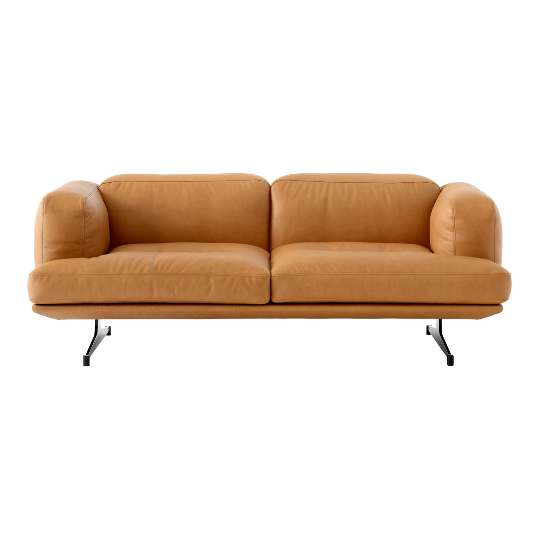 Soft tan leather sofa with rounded cushions and sleek black metal legs, perfect for modern interiors.