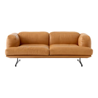 Soft tan leather sofa with rounded cushions and sleek black metal legs, perfect for modern interiors.