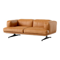 Tan leather sofa with a smooth texture and minimalist design, featuring sleek black metal legs.