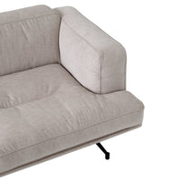 Light beige tufted fabric sofa with a sleek black metal frame, creating a modern and minimalistic aesthetic.