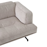 Light beige fabric sofa with a smooth texture and minimalist design, featuring subtle tufted patterns and black metal legs.