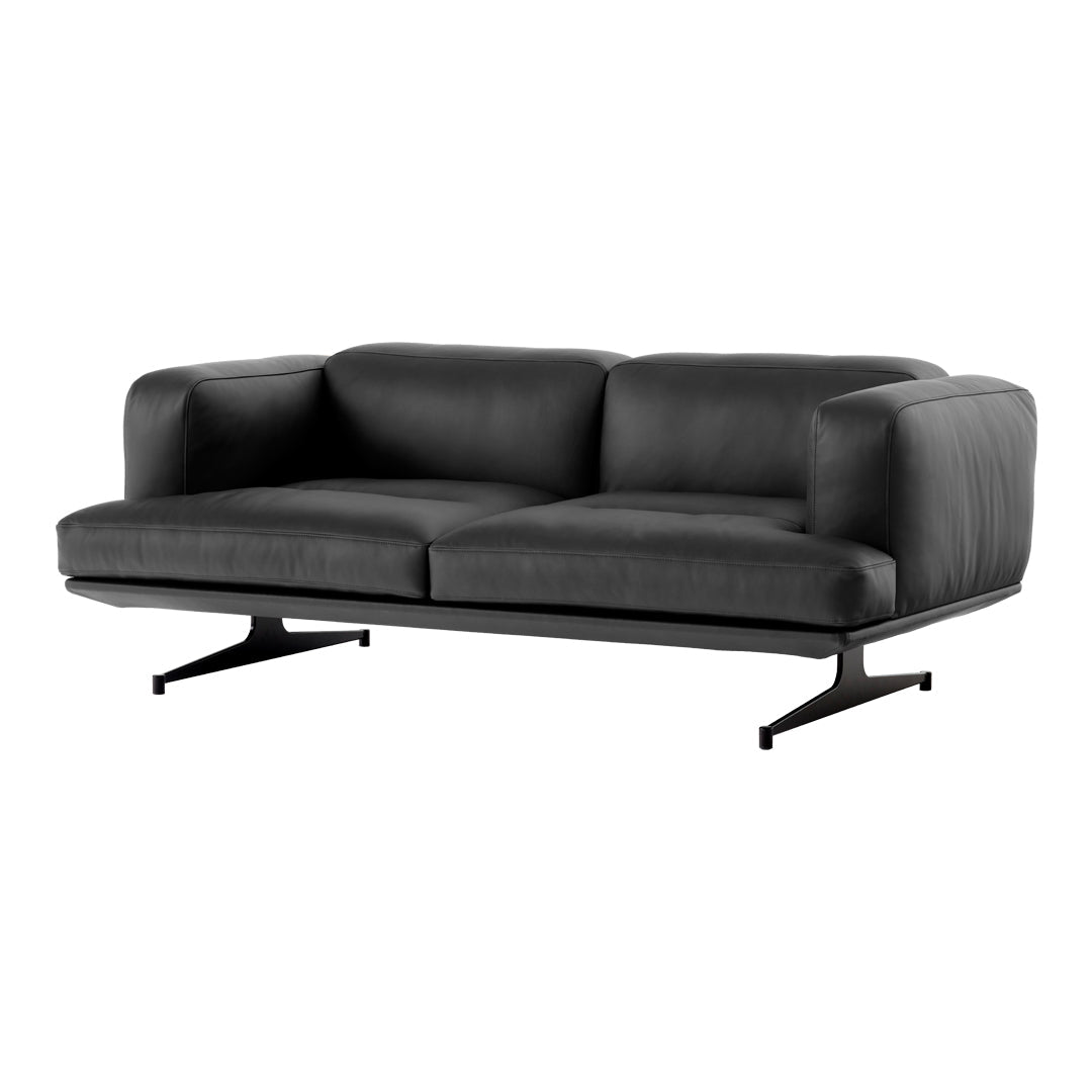 Sleek black leather sofa with a smooth finish and modern design, featuring minimalist metal legs.
