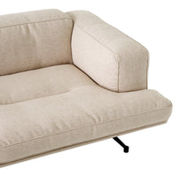 Light beige upholstered sofa with a smooth texture and minimalist design, featuring a clean, neutral color palette.
