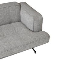 Gray upholstered sofa with a sleek, modern design and smooth texture, featuring minimalistic lines and subtle block patterns.