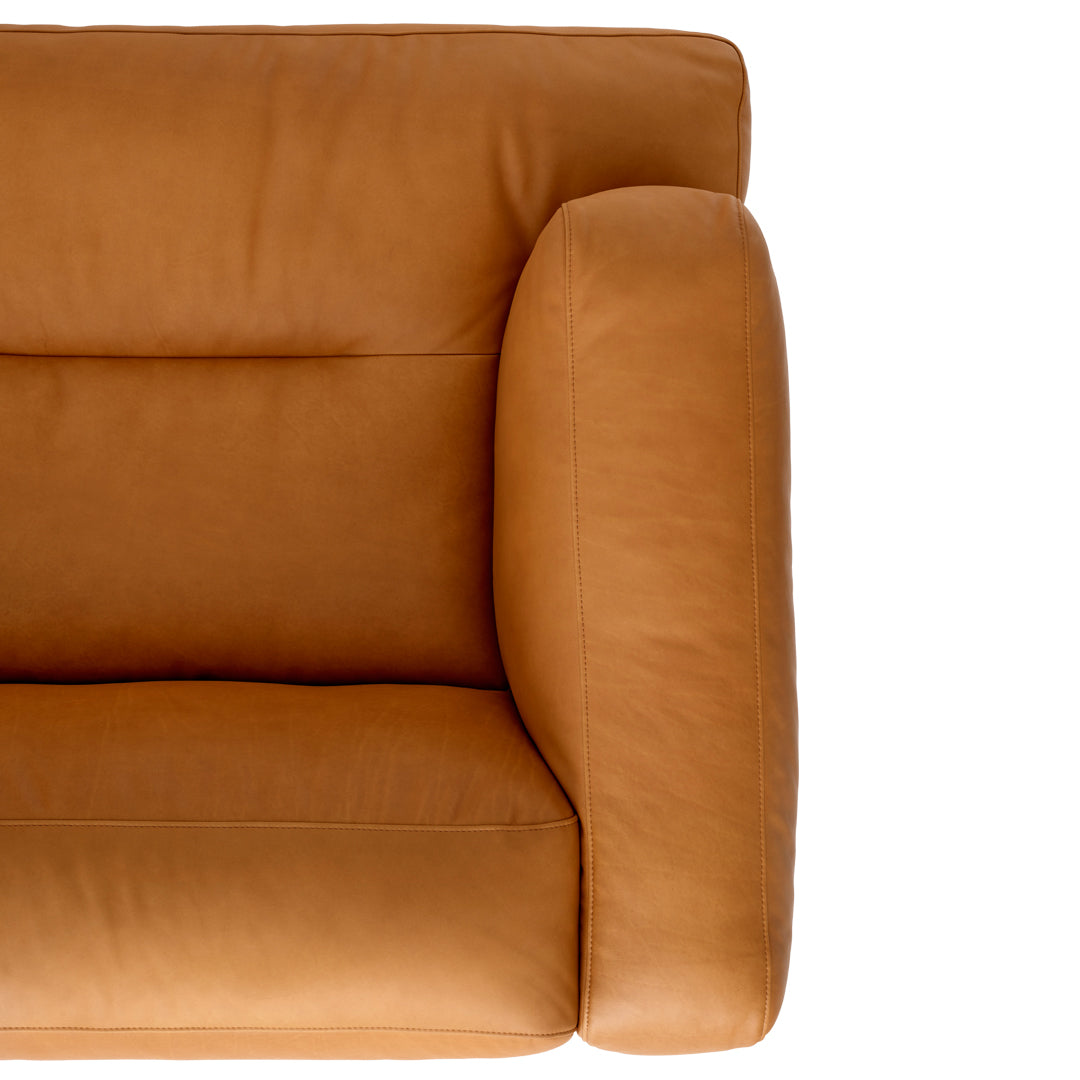 Tan leather couch with a smooth texture and minimalistic design, featuring a sleek armrest for modern decor.