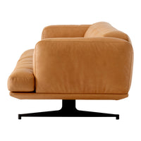 Modern tan leather sofa with a sleek design and smooth, clean lines, featuring a minimalist black metal base.