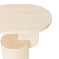 Natural light wood table with a smooth, oval top and rounded base, showcasing a minimalist design and subtle grain patterns.
