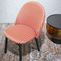 Orange and white striped chair with black legs, set against a textured background. Modern and vibrant design.